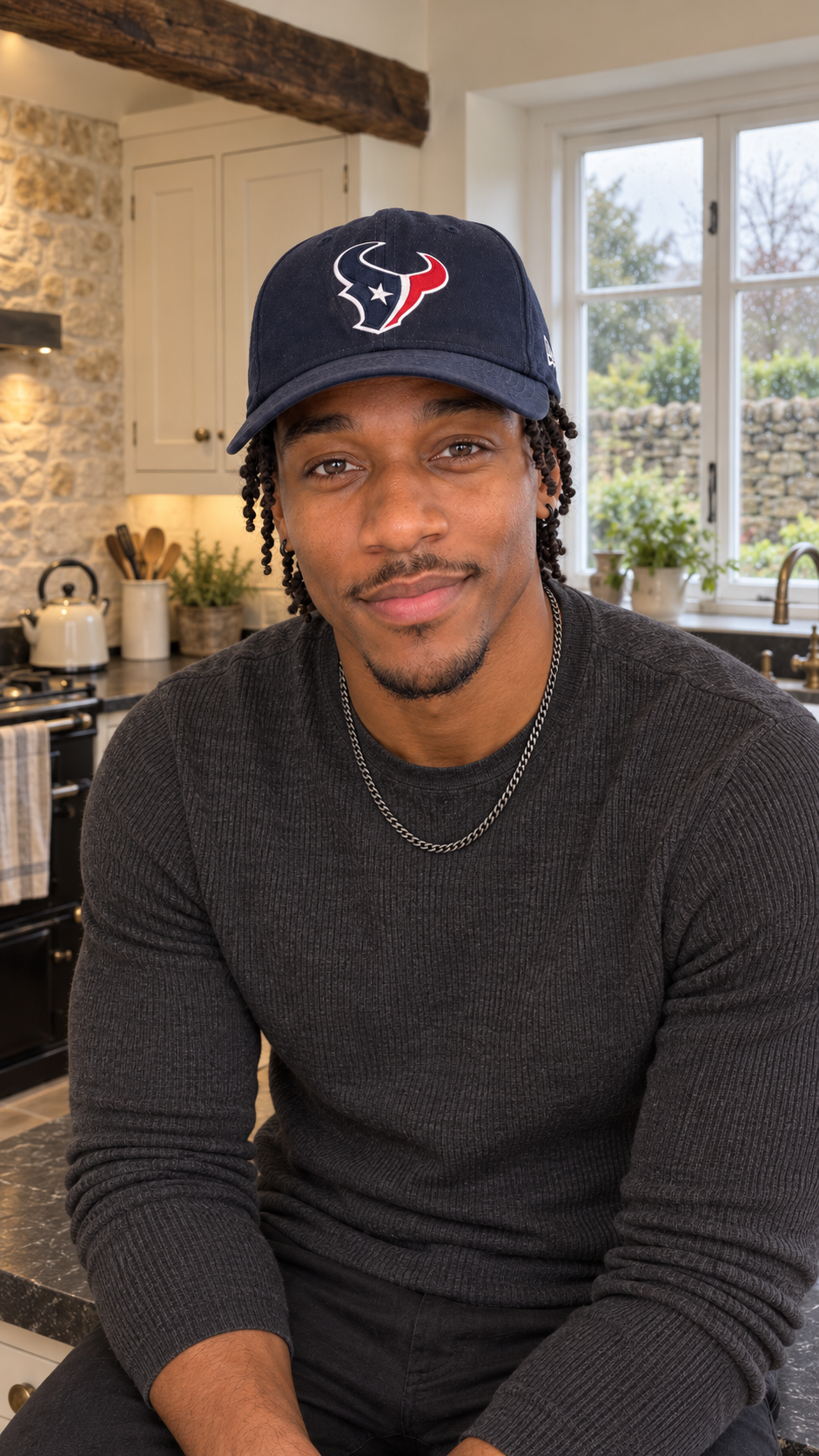 Cameron James in his kitchen, wearing a dark sweater and cap.